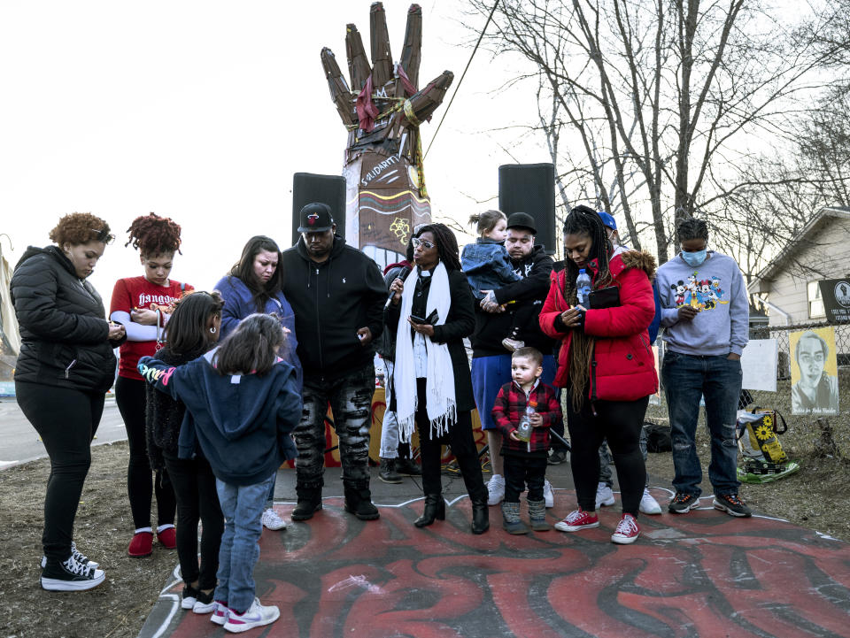 The family of Daunte Wright gather for a moment of prayer at a vigil honoring Wright, on the one-year anniversary of his death Monday, April 11, 2022, in Brooklyn Center, Minn. Wright was fatally shot by a Minnesota police officer during a traffic stop. (Carlos Gonzalez/Star Tribune via AP)