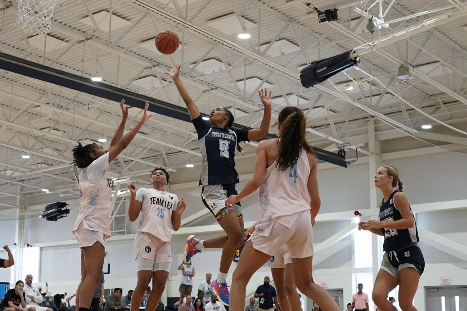 West Virginia Thunder's Darianna Alexander (9) shoots past California Storm Taurasi defenders during their game at the NCAA College Basketball Academy, Saturday, July 29, 2023 in Memphis, Tenn. Zakiyah Johnson, Darianna Alexander and Divine Bourrage are three of the top high school prospects chasing the dream of playing women's college basketball, yet not even they can escape the stressful challenges of the ever-changing demands of the recruiting landscapes. (AP Photo/George Walker IV)