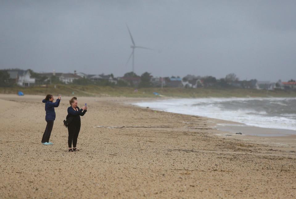 People visit Johnnie Walker beach in Lewes on the Delaware Bay to gauge the effects of tropical storm Ophelia Saturday afternoon, Sept. 23, 2023.