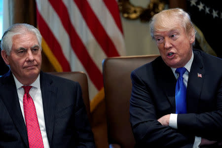 U.S. President Donald Trump, flanked by Secretary of State Rex Tillerson, holds a cabinet meeting at the White House in Washington, U.S., December 20, 2017. REUTERS/Jonathan Ernst