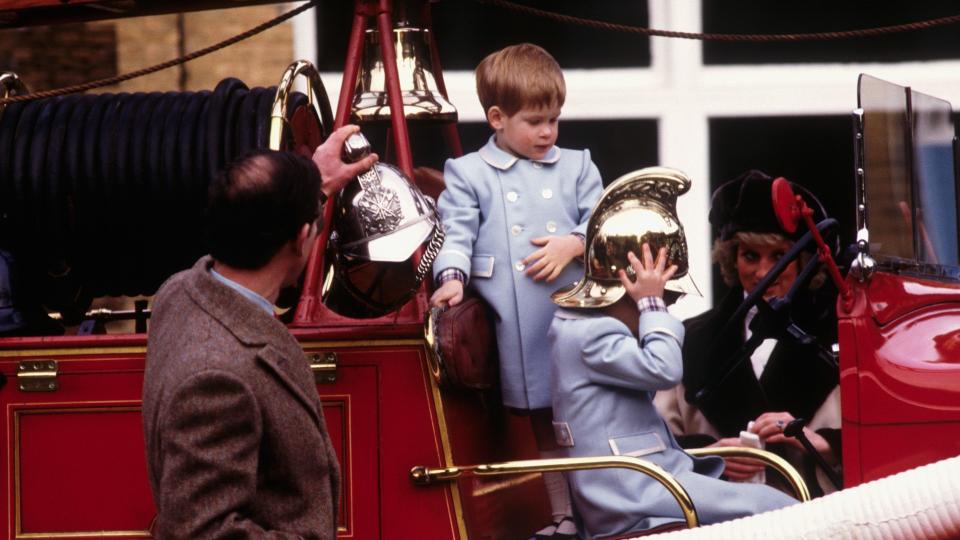 Prince William and Harry playing on a fire engine