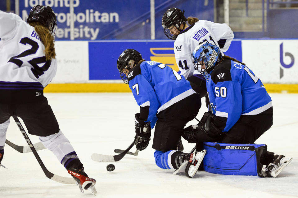 Minnesota forward Abby Boreen (24) attempts to score on Toronto goaltender Kristen Campbell (50) as Toronto defender Olivia Knowles (7) defends during the first period of a PWHL hockey game in Toronto, Ontario, Saturday, Feb. 3, 2024. (Christopher Katsarov/The Canadian Press via AP)