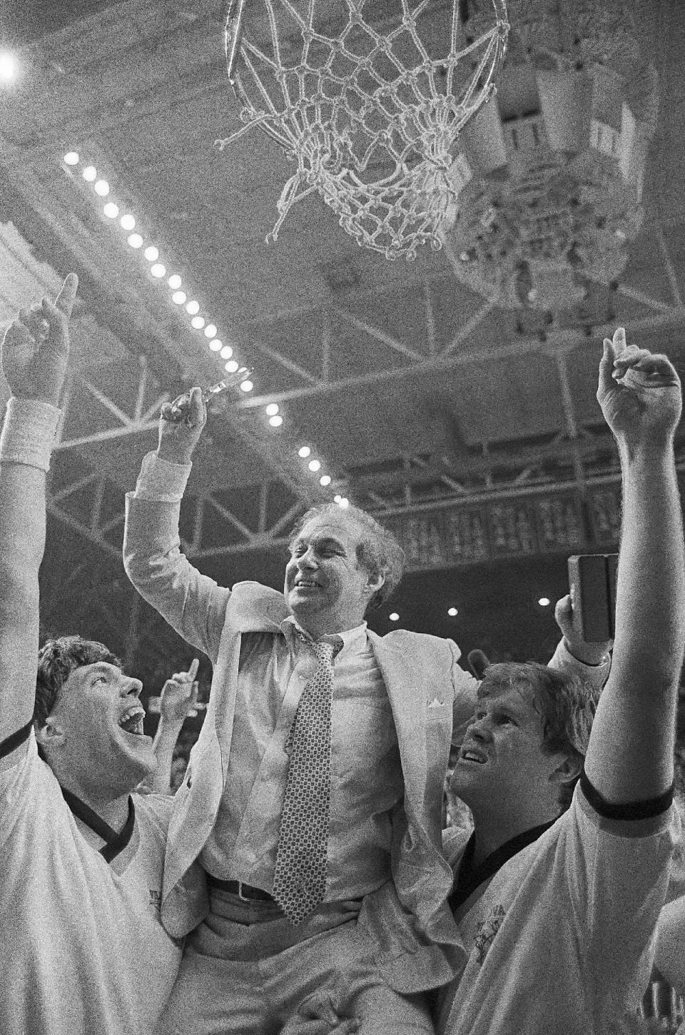 FILE - In this April 2, 1985, file photo, Villanova coach Rollie Massimino, scissors in hand, is boosted aloft to cut the net down after the Wildcats won the NCAA championships in Lexington, Ky.Massimino is among the 14 finalists unveiled Saturday, Feb. 18, 2017, for this year's Basketball Hall of Fame induction class. (AP Photo/Bob Jordan, File)