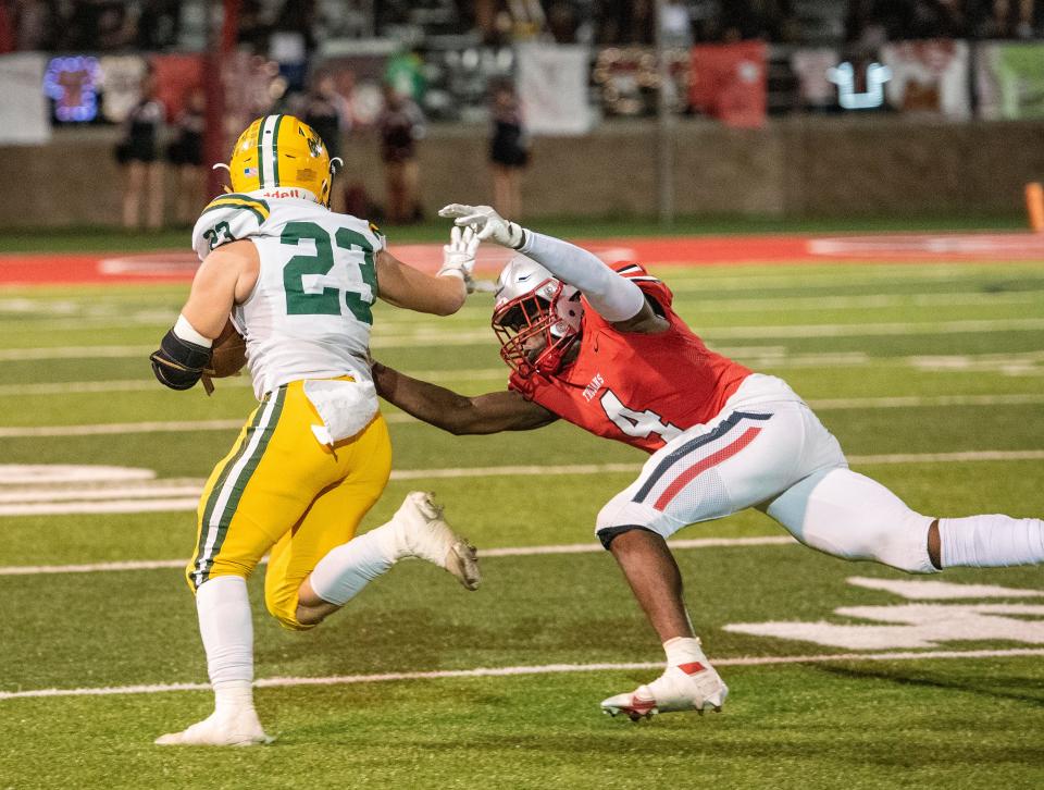 Lincoln's Daniel Emojevbe is unable to bring down Tracy's Mason Meyers on Friday, Sept. 30, 2022.