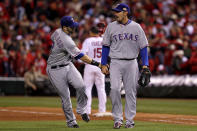 ST LOUIS, MO - OCTOBER 27: Mike Adams #37 (R)and Mitch Moreland #18 of the Texas Rangers celebrate after getting the last out of the eighth inning during Game Six of the MLB World Series against the St. Louis Cardinals at Busch Stadium on October 27, 2011 in St Louis, Missouri. (Photo by Ezra Shaw/Getty Images)