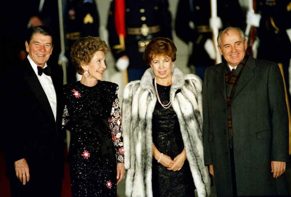 FILE - President Ronald Reagan and first lady Nancy Reagan greet Soviet leader Mikhail Gorbachev and his wife Raisa outside the White House before a State Dinner, Dec. 8, 1987. When Mikhail Gorbachev is buried Saturday at Moscow's Novodevichy Cemetery, he will once again be next to his wife, Raisa, with whom he shared the world stage in a visibly close and loving marriage that was unprecedented for a Soviet leader. Gorbachev's very public devotion to his family broke the stuffy mold of previous Soviet leaders, just as his openness to political reform did. (AP Photo/Ron Edmonds, File)