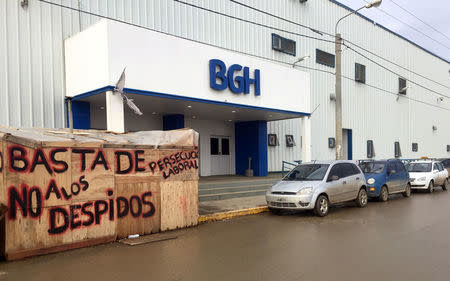 A graffiti that reads "Enough of labor persecution. No more layoffs" is seen outside BGH SA electronics and appliances manufacturing plant in Rio Grande, Tierra del Fuego, Argentina July 26, 2017. REUTERS/Luc Cohen