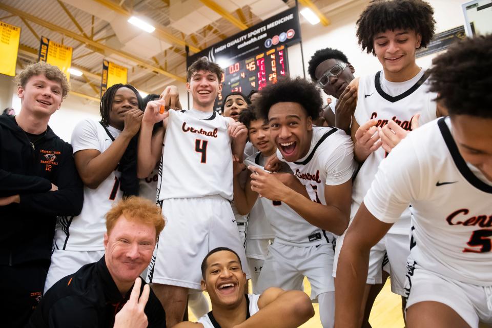 Central York players including JoJo Woodard (second from left) pose for photos after winning the YAIAA boys' basketball championship game against York Suburban Friday, Feb. 16, 2024, at Red Lion Area High School. The Panthers defeated the Trojans, 63-45, to win back-to-back titles.