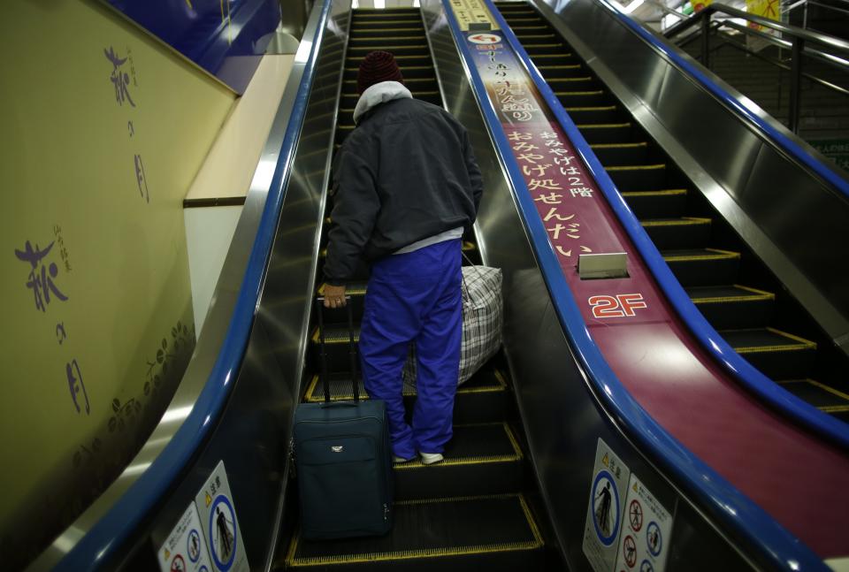 Shizuya Nishiyama, a 57-year-old homeless man from Hokkaido, takes an escalator at Sendai Station