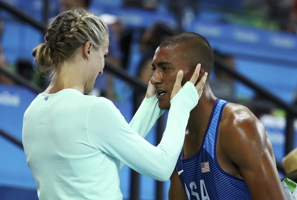 <p>Ashton Eaton of United States speaks with his wife Brianne Theisen Eaton of Canada on winning silver after the heptahlon during Day Four of the 14th IAAF World Athletics Championships Moscow 2013 at Luzhniki Stadium on August 13, 2013 in Moscow, Russia. (Photo by Julian Finney/Getty Images) </p>