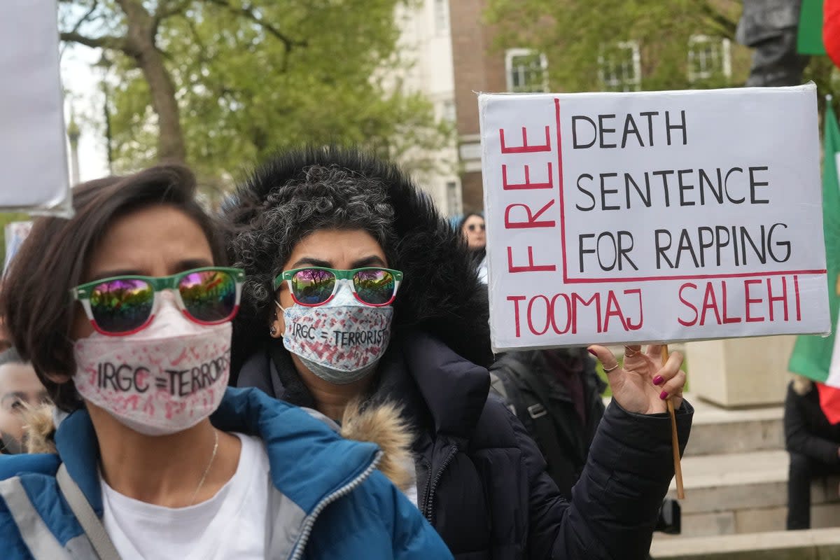 Protesters with placards and signs opposite Downing Street in London (PA Wire)