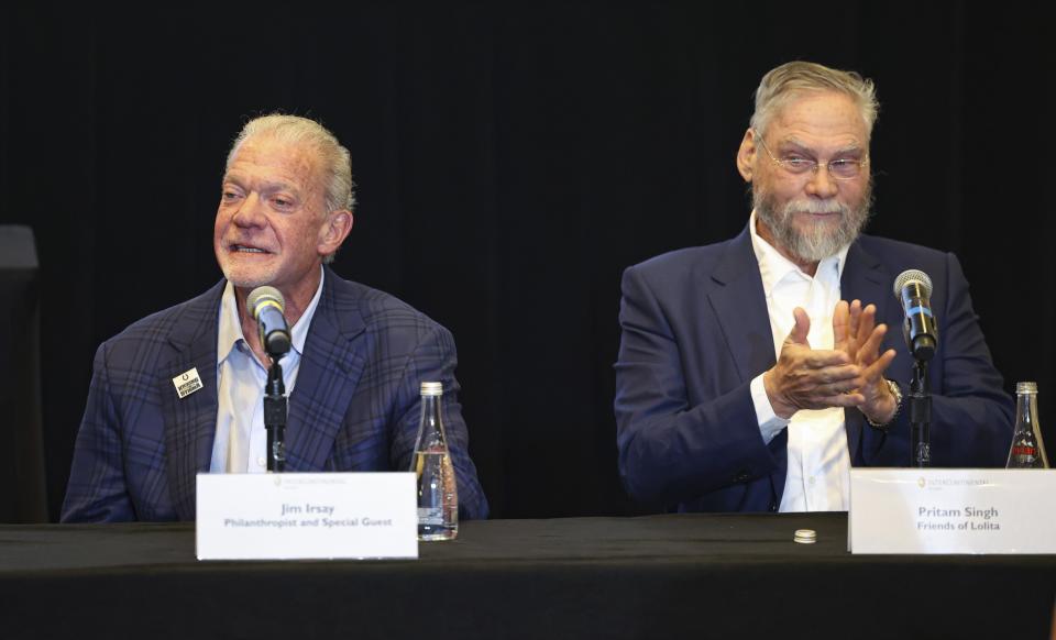 Jim Irsay, CEO of the Indianapolis Colts, left, talks as Pritam Singh, Friends of Lolita, claps during a press conference to discuss the future of Lolita, an orca that has lived at the Miami Seaquarium for more than 50 years, Thursday, March 30, 2023, at the Intercontinental hotel in Miami. An unlikely coalition of a theme park owner, animal rights group and NFL owner-philanthropist announced Thursday that a plan is in place to return Lolita to her home waters in the Pacific Northwest. (Alie Skowronski/Miami Herald via AP)