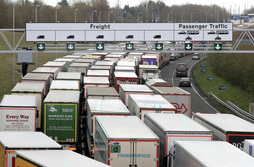 Heavy good lorries queue to enter the Eurotunnel site in Folkestone, southern England, as French customs officers continue their work-to-rule industrial action, Tuesday March 19, 2019.  French customs workers are protesting over pay and to show the effect of Britain's Brexit from Europe will have on cross-Channel traffic. (Gareth Fuller/PA via AP)