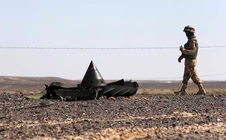 An Egyptian army soldier stands guard near debris from a Russian airliner which crashed at the Hassana area in Arish city, north Egypt, November 1, 2015. REUTERS/Mohamed Abd El Ghany