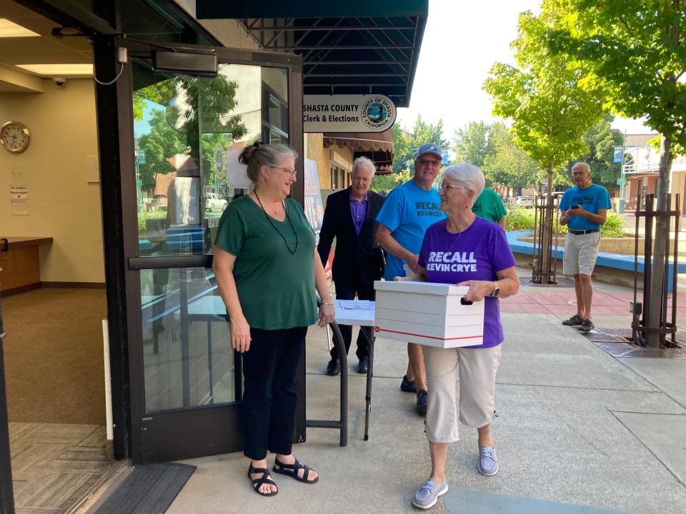 Supporters of the effort to recall Shasta County Supervisor Kevin Crye deliver two boxes of signatures to the county elections office on Tuesday as Registrar of Voters Cathy Darling Allen, left, looks on.