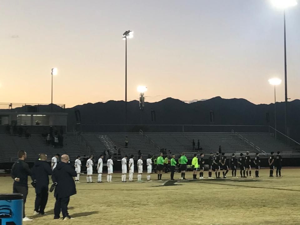 Casteel and Verrado boys varsity soccer teams line up for the national anthem before kickoff on Tuesday, Jan. 18, 2022, at Verrado High School.