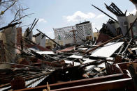 <p>A cross stands next to the altar in a church destroyed by Hurricane Matthew in Camp Perrin, Haiti, October 8, 2016. (REUTERS/Andres Martinez Casares)</p>