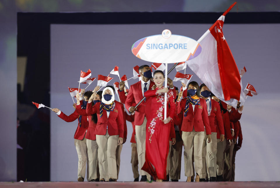 The Singapore contingent enters the My Dinh Stadium during the Hanoi SEA Games opening ceremony. 