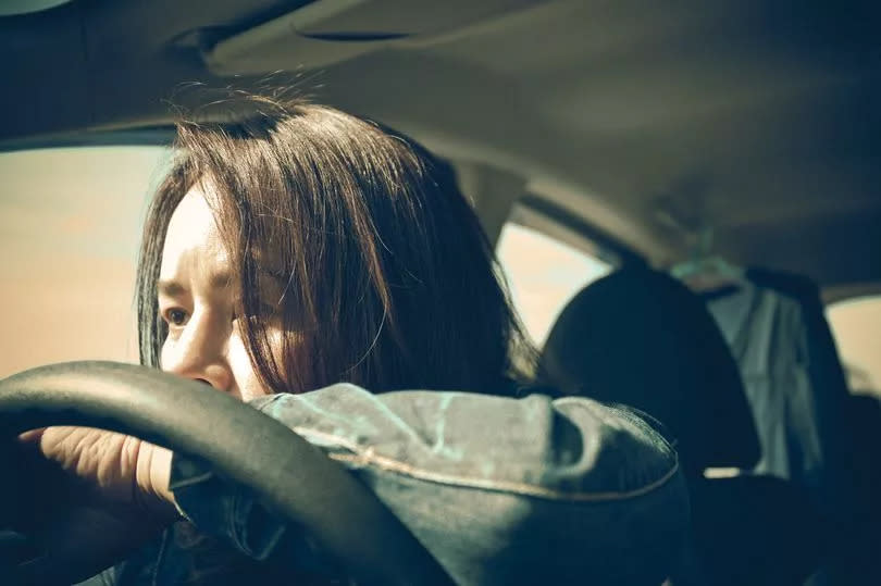 Stock image of a person behind the wheel of a car