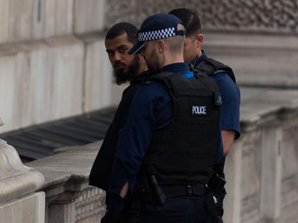 Police detain a man following an incident in Whitehall; a bag and three knives were found at the scene (EPA)