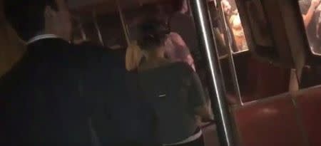 Passengers evacuate from a train in the dark following a subway train incident in the Manhattan borough of New York, United States June 27, 2017, in this still image taken from a video obtained from social media. Twitter/@cutdekProd/via REUTERS