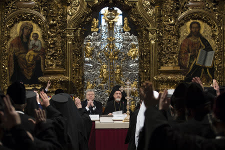 Ukraine's President Petro Poroshenko (L) and a special envoy of Ecumenical Patriarch Metropolitan Emmanuel of France attend a church council to convene to create an independent Ukrainian Orthodox church at the Saint Sophia's Cathedral in Kiev, Ukraine December 15, 2018. Mikhail Palinchak/Ukrainian Presidential Press Service/Handout via REUTERS