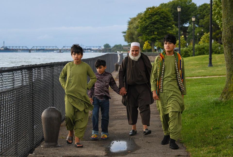 Aug 7, 2023; Buffalo, NY, USA From left, Irshad Shams, 12, Mustafa Shams, 8, Mohammad Hakim Hotak, 68, and Mohammad Shams, 14, take a walk in Broderick Park in Buffalo, N.Y., Tuesday, August 7, 2023. Mohammed, 14, arrived alone to the USA in November 2021, just two months after the fall of Kabul. He didn't speak English and had no other relatives with him. At the two-year anniversary of the U.S.'s hasty retreat from Afghanistan, authorities continue to struggle with what to do with the remaining Afghan youths in U.S. custody.