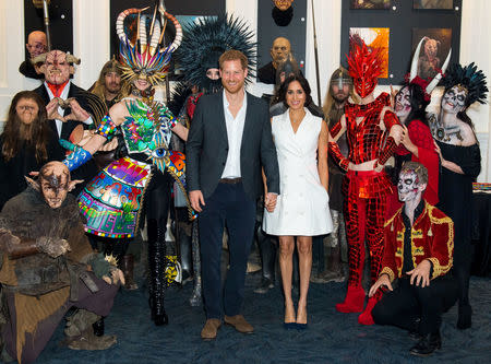 Britain's Prince Harry and Meghan, Duchess of Sussex, meet actors in costumes during a visit to Courtenay Creative, in Wellington, New Zealand October 29, 2018. Dominic Lipinski/Pool via REUTERS