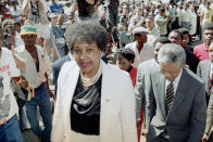 <p>Winnie Mandela, left, wife of African National Congress leader Nelson Mandela, right, arrives at the Johannesburg Supreme Court on Feb. 5, 1991, where Mrs. Mandela is facing charges of kidnapping and assault. (Photo: John Parkin/AP) </p>