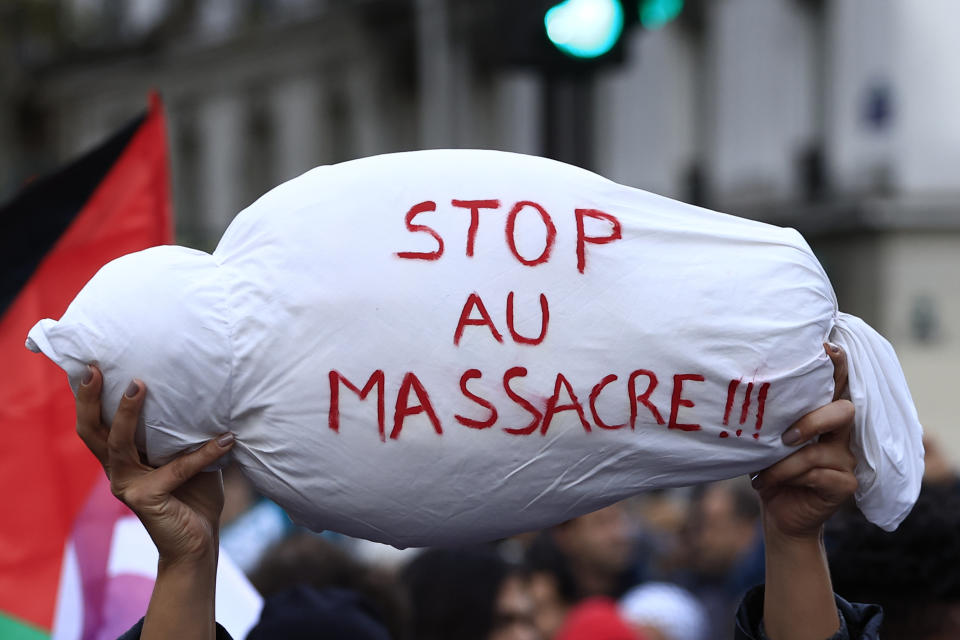 A mock child's body is carried during a demonstration to support the Palestinian people in Gaza, Saturday, Nov. 4, 2023 in Paris. (AP Photo/Aurelien Morissard)