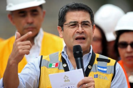 FILE PHOTO: Honduras' President Juan Orlando Hernandez addresses the audience during a visit to the construction site of the new facilities of the Government of Honduras in Tegucigalpa, Honduras, January 29, 2018. REUTERS/Edgard Garrido