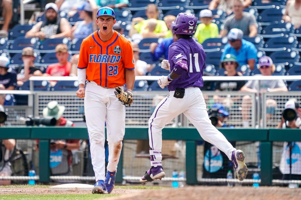 Florida first baseman Luke Heyman (28) celebrates after an out against TCU during their game at Charles Schwab Field Omaha.