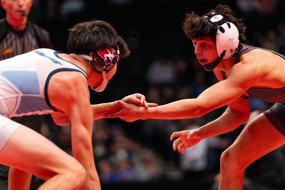 Windsor's James Pantoja starts his third place match against Riverdale Ridge's Mikey Medina during the Colorado state wrestling tournament at Ball Arena on Saturday, Feb. 18, 2023 in Denver, Colo.