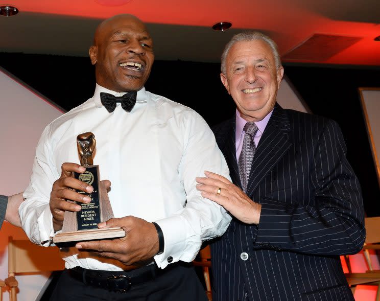 Former heavyweight champion Mike Tyson (L) and broadcaster Barry Tompkins share a laugh at the Nevada Boxing Hall of Fame ceremony in 2013. On Tuesday, Tompkins and broadcast partner Steve Farhood were both elected to the International Boxing Hall of Fame. (Ethan Miller/Getty Images)