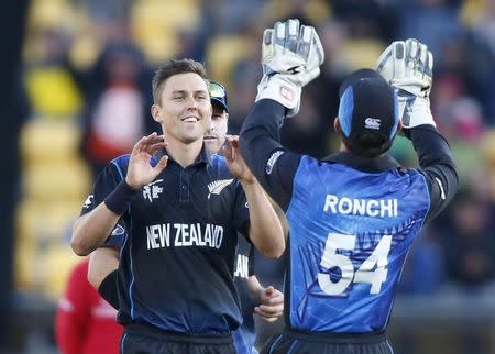 New Zealand's Trent Boult (L) celebrates dismissing Johnson Charles of the West Indies during their Cricket World Cup match in Wellington, March 21, 2015. REUTERS/Nigel Marple