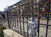 A man walks past an apartment building damaged by shelling by Azerbaijan's forces during a military conflict in Shushi, outside Stepanakert, the separatist region of Nagorno-Karabakh, Thursday, Oct. 29, 2020. Fighting over the separatist territory of Nagorno-Karabakh continued on Thursday, as the latest cease-fire agreement brokered by the U.S. failed to halt the flare-up of a decades-old conflict between Armenia and Azerbaijan. (AP Photo)