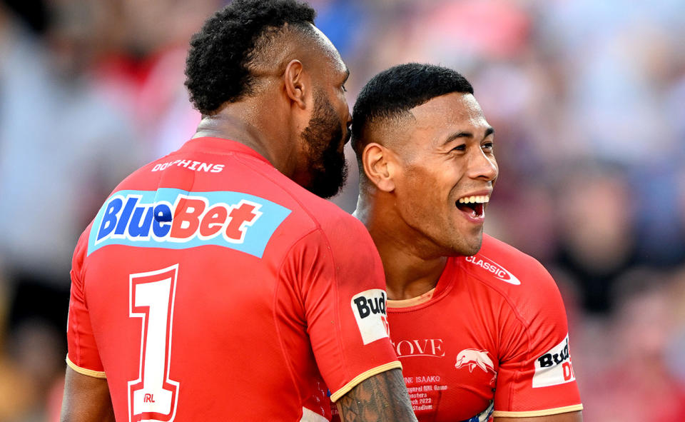 Dolphins players, pictured here celebrating during their win over the Sydney Roosters at Suncorp Stadium.