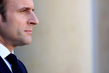 FILE PHOTO: French President Emmanuel Macron watches as German Chancellor Angela Merkel departs after a meeting at the Elysee Palace in Paris, France, February 27, 2019. REUTERS/Gonzalo Fuentes/File Photo