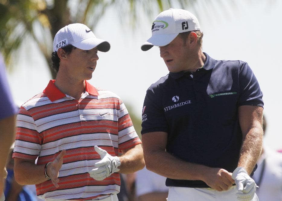 Rory McIlroy, left, of Northern Ireland, and Jamie Donaldson of Wales, talk before hitting from the third tee during the third round of the Cadillac Championship golf tournament Saturday, March 8, 2014, in Doral, Fla. (AP Photo/Marta Lavandier)