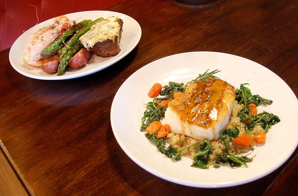 Two of the Valentine's Day specials at The Copper Mug Bar & Grille at Landoll's Mohican Castle are shown here on Wednesday, Feb. 9, 2022 in the foreground is the Pan Seared Seabass and Gorgonzola Crusted Filet Mignon with prawns. TOM E. PUSKAR/TIMES-GAZETTE.COM