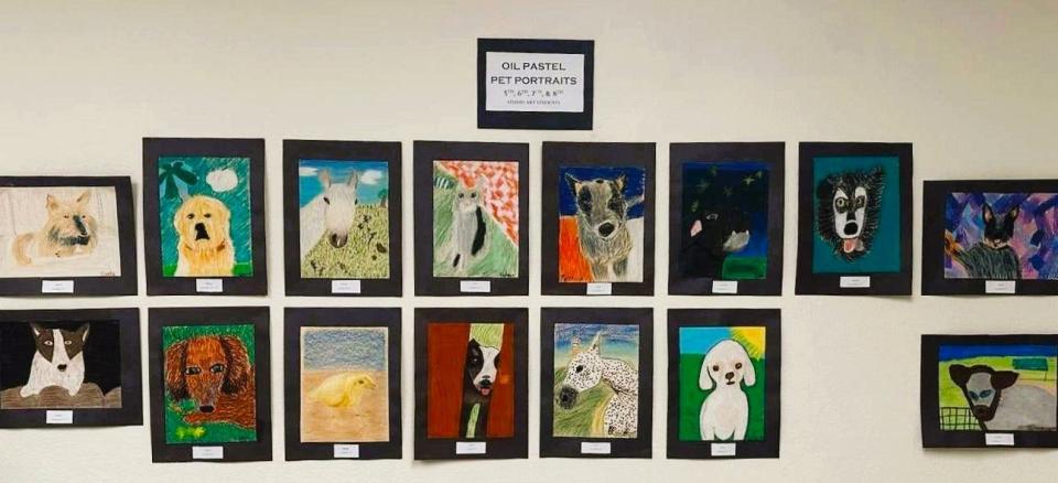 Students at Holy Family Classical Academy in Wichita Falls created oil pastel portraits of their pets that were displayed at the school in October 2023.