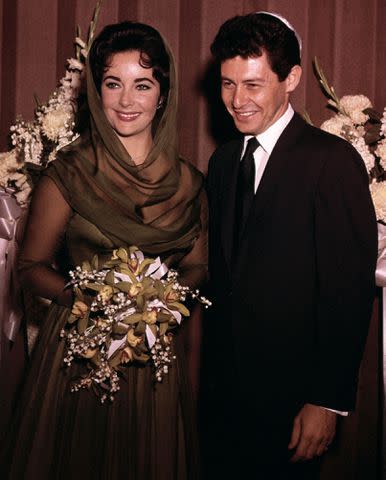 <p>Bettmann</p> Eddie Fisher and Elizabeth Taylor are shown after their wedding in 1959.