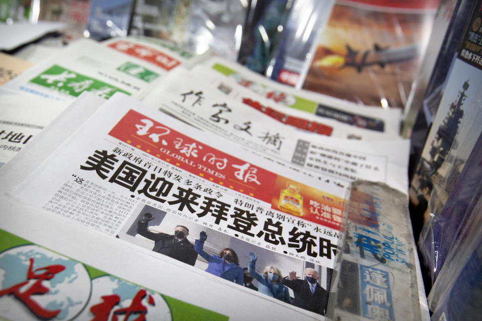 A copy of the Chinese state-run Global Times newspaper with a front page devoted to coverage of the inauguration of President Joe Biden is displayed at a newsstand in Beijing, Thursday, Jan. 21, 2021. China has expressed hope the Biden administration will improve prospects for people of both countries and give a boost to relations after an especially rocky patch, while getting in a few final digs at former Trump officials. (AP Photo/Mark Schiefelbein)