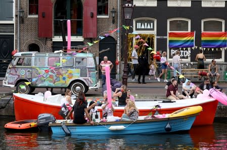 Participants are seen at the canals during the annual gay pride parade in Amsterdam