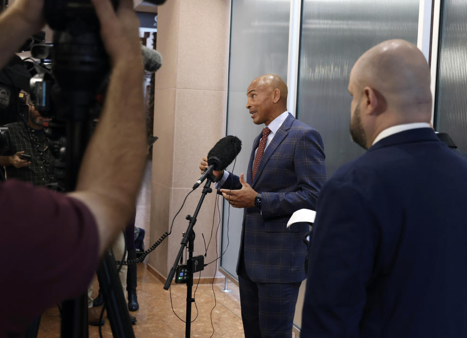 CORRECTS TO DUANE "KEFFE D" DAVIS. Attorney Carl Arnold, center, representing Duane "Keffe D" Davis, addresses the media after Davis' status hearing at the Regional Justice Center, on Tuesday, Feb. 20, 2024, in Las Vegas. A trial date has been pushed back from June to November for the former Los Angeles-area gang leader charged with killing hip-hop music icon Tupac Shakur in 1996 in Las Vegas. Davis' new attorney said Tuesday in court that he expects to be able to post bail soon to be released from jail to house arrest. (Bizuayehu Tesfaye/Las Vegas Review-Journal via AP, Pool)