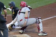St. Louis Cardinals catcher Andrew Knizner, right, tags out Pittsburgh Pirates' Diego Castillo, who tried to score from third on a ground ball by Jason Delay during the sixth inning of a baseball game Wednesday, Oct. 5, 2022, in Pittsburgh. (AP Photo/Keith Srakocic)