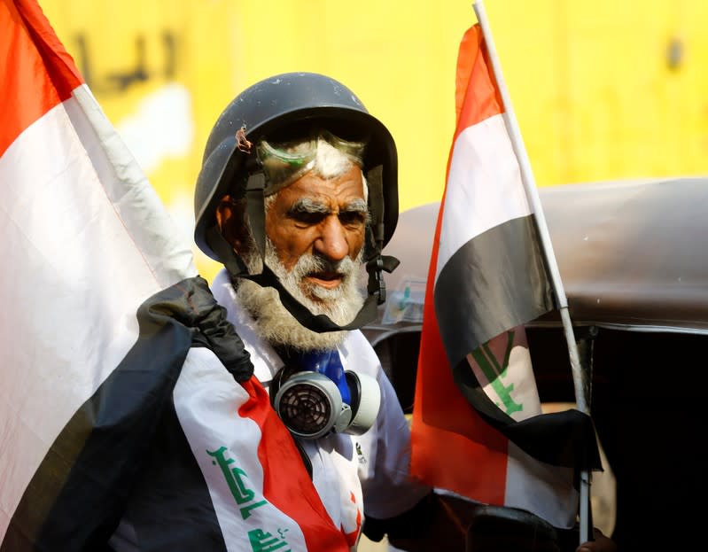 Demonstrator holds the Iraqi flag during the ongoing anti-government protests in Baghdad