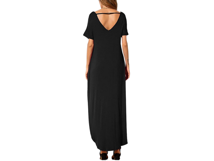A rear view of a model in a black maxi dress from Grecerelle.