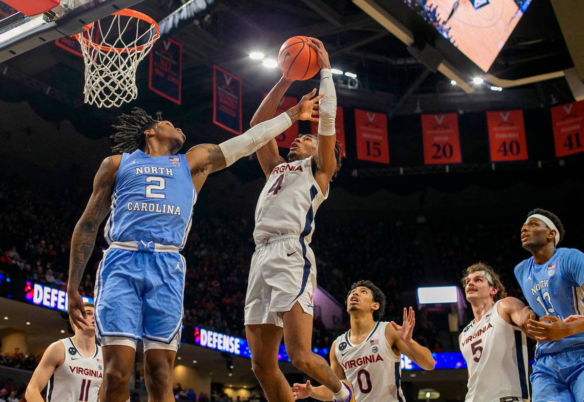 Virginia’s Armaan Franklin (4) secures a defensive rebound against North Carolina’s Caleb Love (2) in the second half on Tuesday, January 10, 2023 at John Paul Jones Arena in Charlottesville, Va.