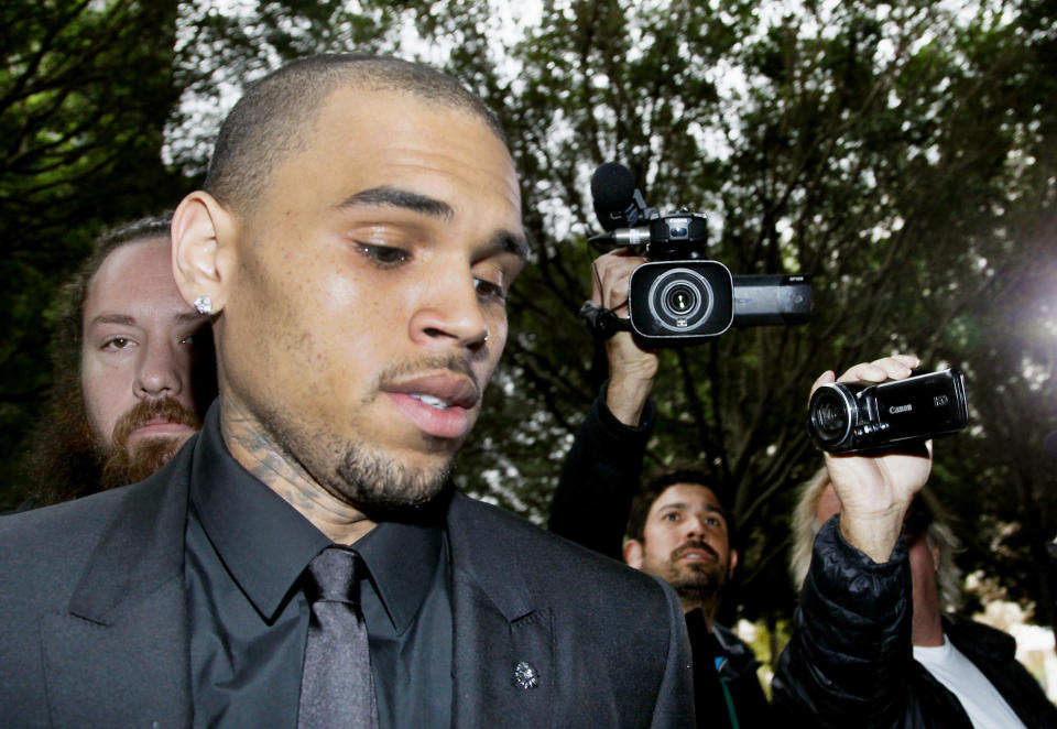 FILE - In this Wednesday, Nov. 20, 2013, file photo, singer Chris Brown arrives at court for a probation review hearing , in Los Angeles. A judge on Monday, Dec. 16, 2013, revoked Brown's probation after his recent arrest on suspicion of misdemeanor assault in Washington, D.C., but the ruling will not alter the singer's requirements to complete rehab and community labor for his 2009 attack on Rihanna. (AP Photo/ Nick Ut, File)